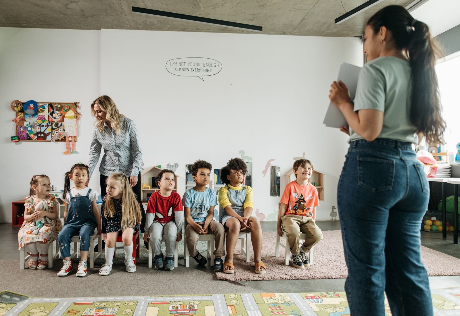 Children and their therapist together in a bright therapy room