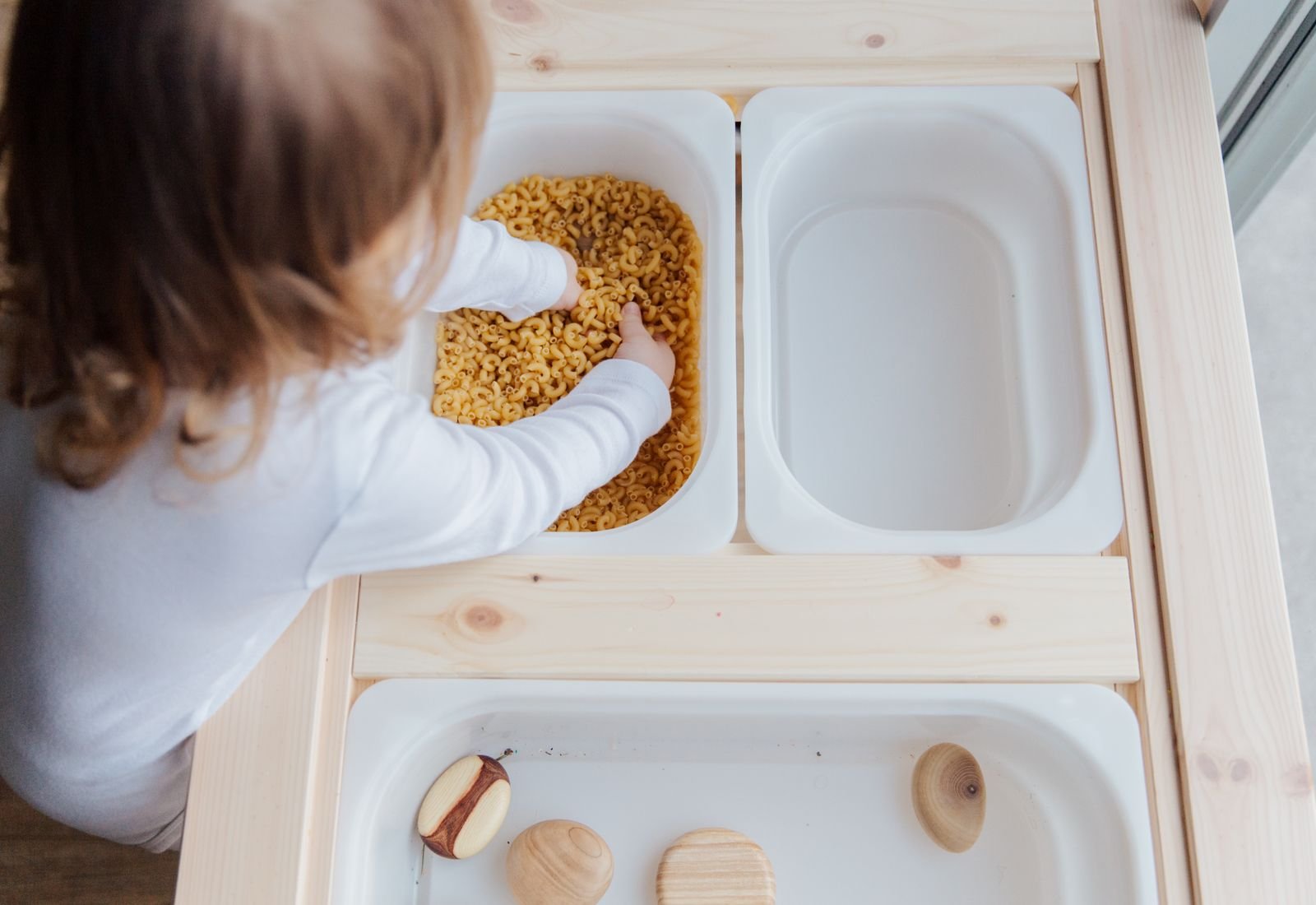 A child exploring textures during sensory play